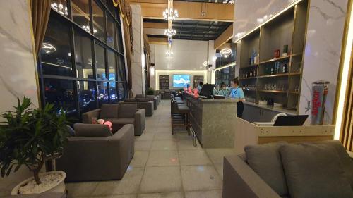 a bar in a restaurant with couches and a counter at Legend Hotel and Resort in Sihanoukville