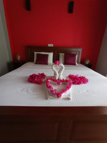 a bed with a heart made out of roses at Villa Ingrid in Aluthgama