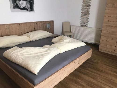 a bed with two pillows on top of it at Apart Mangweth in Nauders