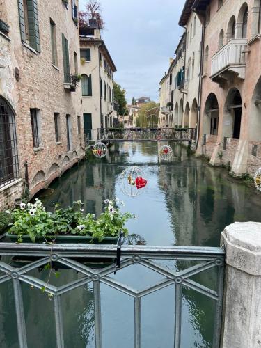 a view of a canal in a city with buildings at My Comfort in Treviso