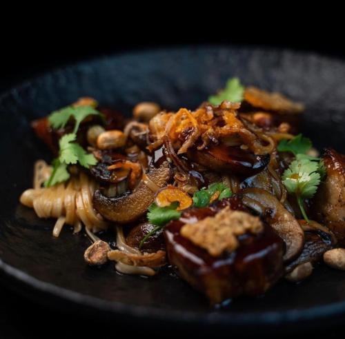 a plate of food with mushrooms and other foods at Hotel Am Markt in Besigheim