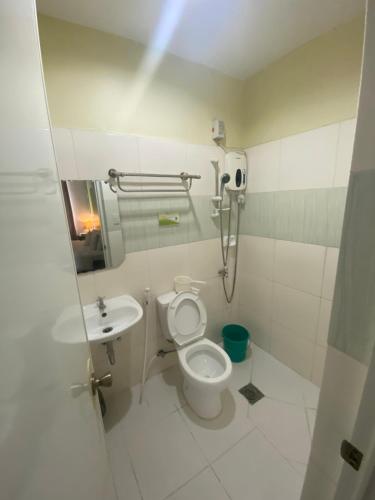 a bathroom with a toilet and a sink at BOPEMPC Safari Hostel in Tagbilaran City