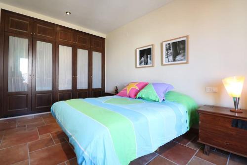 a bedroom with a large bed with colorful pillows at Piso con vista espectacular en Vistabella in Vistabella del Maestrazgo