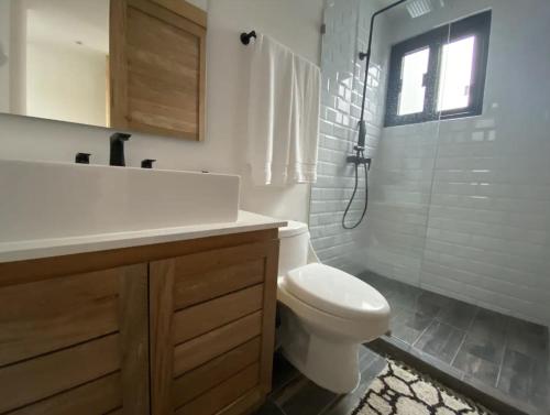 a bathroom with a toilet and a sink and a shower at Casa Kuaan Mani TH 1 in Tulum