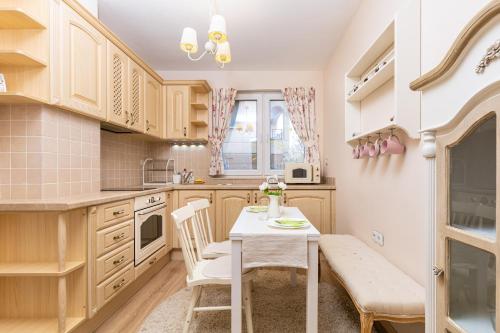 a kitchen with a table and chairs in a room at Bright & Cozy 1BD Flat with a Terrace and Parking in Plovdiv