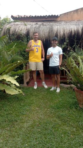 two men standing in front of a hut at Sigiriya Nature View home Stay in Sigiriya