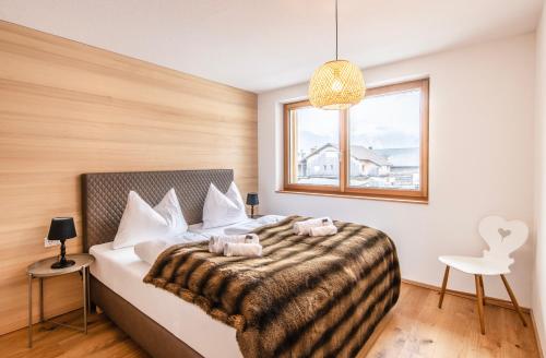 a bedroom with a bed with two towels on it at Huus123 in Au im Bregenzerwald