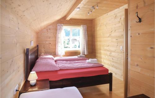a bedroom with a red bed in a wooden room at Pet Friendly Home In Dalaas With Wifi in Dalaas