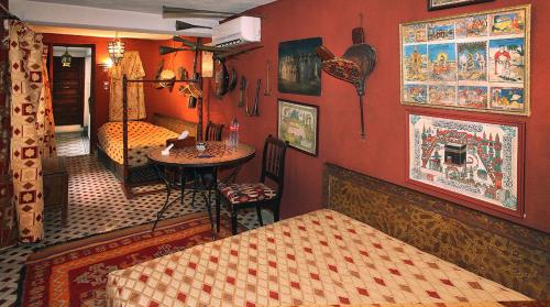 Zimmer mit einem Schlafzimmer mit einem Tisch und einem Bett in der Unterkunft Riad Lune et Soleil in Fès