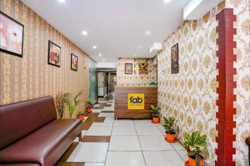 a waiting room with a couch and plants at FabHotel Gargi Deluxe in Pune
