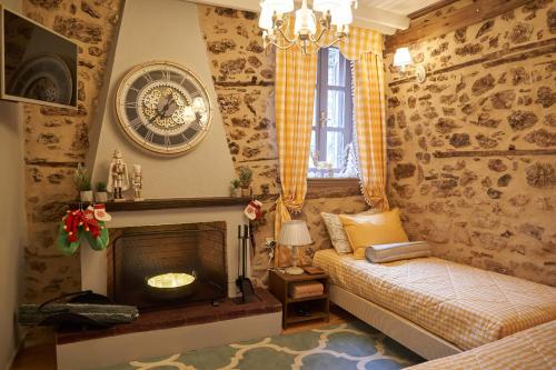 a bedroom with a fireplace and a clock on the wall at Dandy Villas Dimitsana - a family ideal charming home in a quaint historic neighborhood - 2 fireplaces for romantic nights in Dimitsana