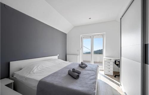 a bedroom with a bed with two towels on it at Amazing Apartment In Murter With Wifi in Murter