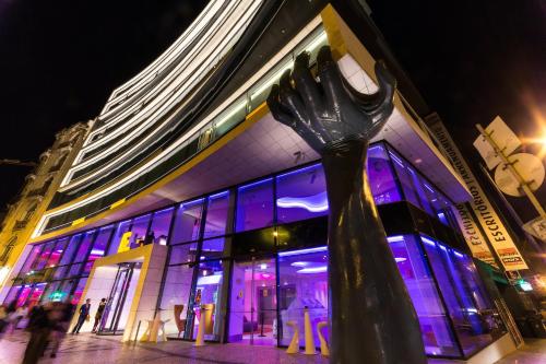 a parking meter in front of a building with purple lights at EVOLUTION Lisboa Hotel in Lisbon