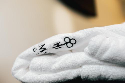 a white towel with the number written on it at Ribeira Collection Hotel by Piamonte Hotels in Arcos de Valdevez