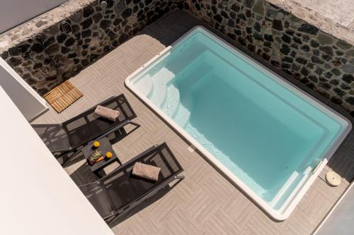 an overhead view of a swimming pool in a hotel room at SantoRossa Luxury Villas in Emporio Santorini