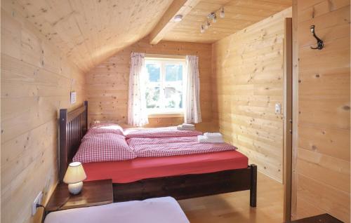 a bed in a wooden room with a window at Awesome Home In Dalaas With 2 Bedrooms And Wifi in Dalaas
