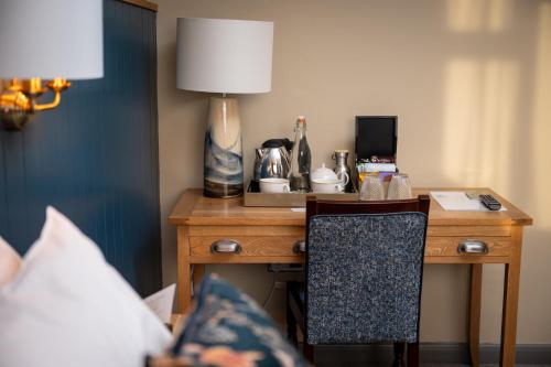 a desk with a lamp and a chair in a room at Riverside Hotel by Chef & Brewer Collection in Burton upon Trent