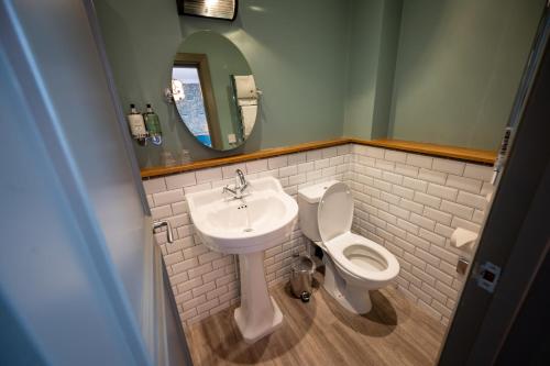 a bathroom with a sink and a toilet and a mirror at Riverside Hotel by Chef & Brewer Collection in Burton upon Trent