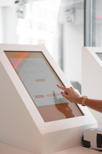 a person pointing at a tablet screen in an office at EVOLUTION Lisboa Hotel in Lisbon