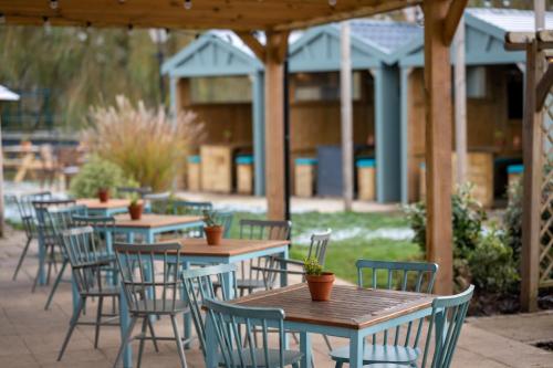 a row of tables and chairs in a patio at Riverside Hotel by Chef & Brewer Collection in Burton upon Trent