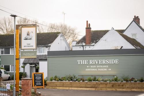 a sign that reads the riverside and inn building at Riverside Hotel by Chef & Brewer Collection in Burton upon Trent