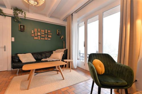 a living room with a couch and a table at A l'Oree du Bois in Labaroche