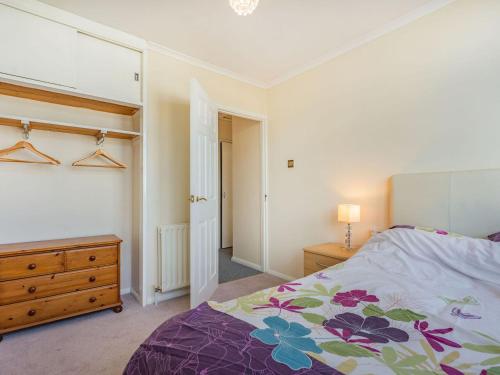 a bedroom with a bed and a wooden dresser at Sea View in Bognor Regis