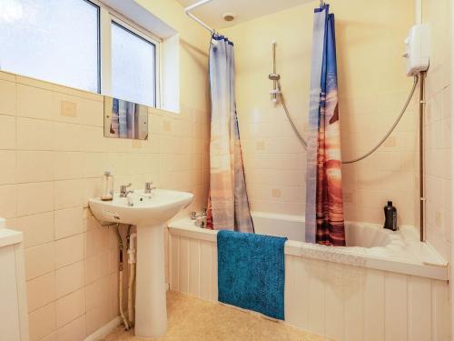 a bathroom with a sink and a tub and a shower at Sea View in Bognor Regis