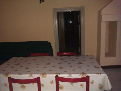 a dining room table with chairs and a tablecloth on it at Guesthouse Seghetto in Valdidentro