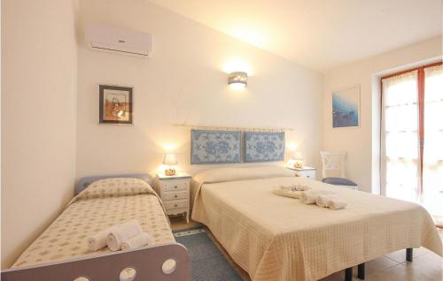 a bedroom with two beds and a window at Villino Mito in San Teodoro
