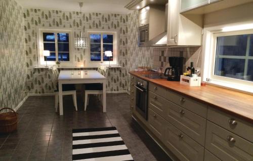 a kitchen with a table and a counter top at Beautiful Home In Gislaved in Gislaved