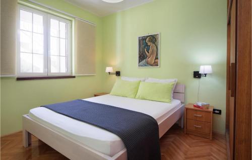 a bedroom with a large bed with green walls at 2 Bedroom Amazing Apartment In Pula in Pula