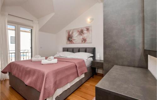 a bedroom with a bed with a pink blanket at Nice Home In Makarska With Heated Swimming Pool in Makar