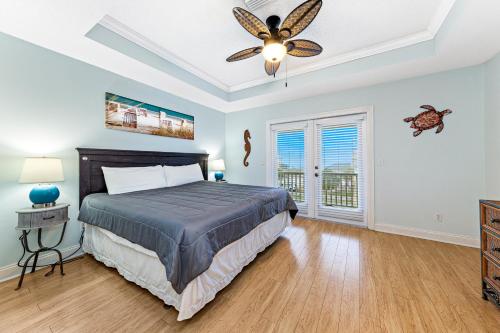 a bedroom with a bed and a ceiling fan at Turtle's Nest West in Gulf Shores