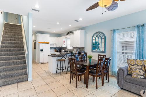 a kitchen and dining room with a table and chairs at Turtle's Nest West in Gulf Shores