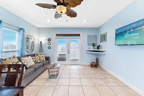 a living room with a couch and a ceiling fan at Turtle's Nest West in Gulf Shores