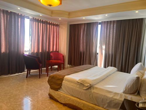 a hotel room with a bed and a table and chairs at Oscar Hotel Petra in Wadi Musa