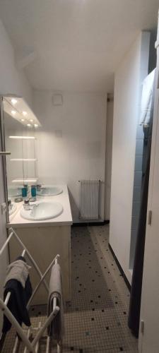 a bathroom with a sink and a mirror at La Fontaine, F2 au cœur de Paray in Paray-le-Monial