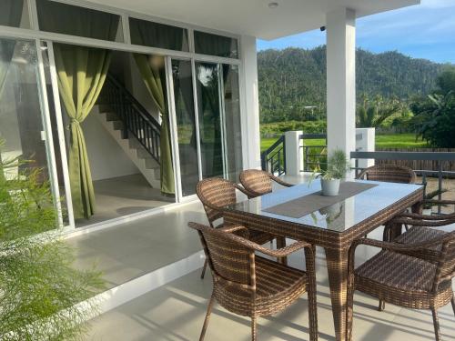 a patio with a table and chairs on a porch at ROYAL SUITES - PORT BARTON in San Vicente