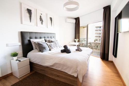 a bedroom with a bed with two teddy bears on it at Apartment Puerto Marina - First Line Beach - Benalmadena - Málaga in Benalmádena