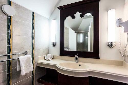 a bathroom with a sink and a mirror at Village Sainte Luce - maeva Home in Sainte-Luce