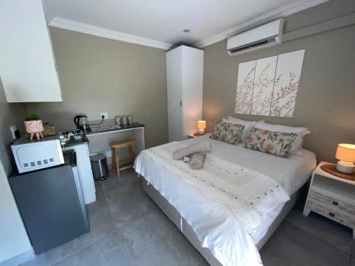 a bedroom with a bed and a sink in it at Guest house on Gillian Unit 5 in Ballito