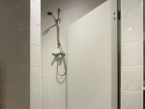 a shower with a shower head in a bathroom at Wijk de Brabander 61 in Cadzand