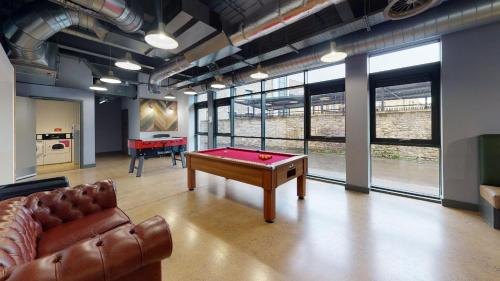 a living room with a pool table and a couch at Twerton Mill in Bath 7 Min Bus to City Centre in Bath