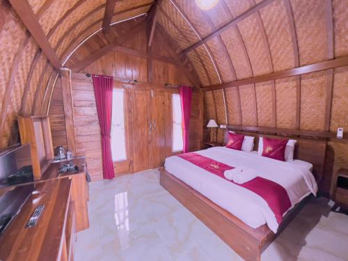 a bedroom with a large bed in a wooden room at Innora Jungle Resort And Spa in Nusa Penida