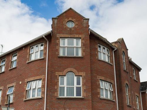 a brick building with a clock tower on top of it at PG McQuaid Suite in Dungannon