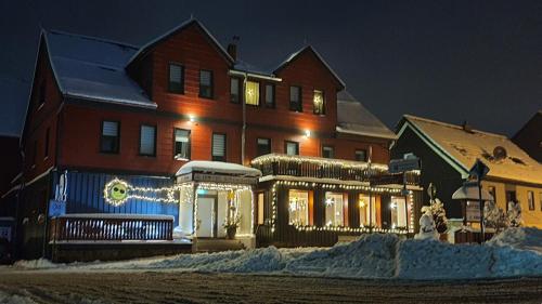 a house with christmas lights in front of it at Hotel Schneiderhof in Braunlage
