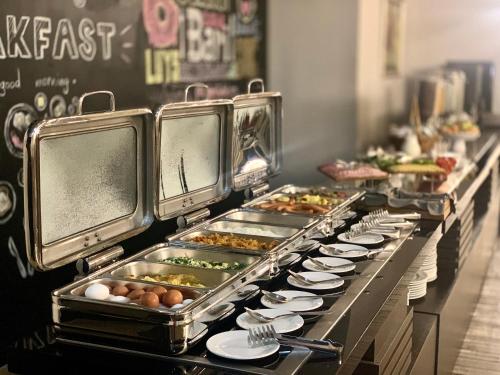 a buffet line with many plates of food at President Hotel by Hrazdan Hotel CJSC in Yerevan