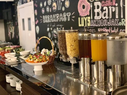 a buffet line with some food and some drinks at President Hotel by Hrazdan Hotel CJSC in Yerevan