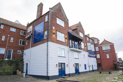 a building with a sign on the side of it at Duke of York in Whitby
